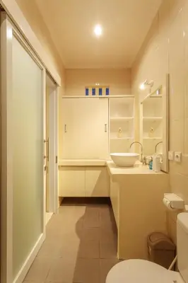a small bathroom with a sink and a toilet at Villa Julie & Villa Sydney, Seminyak - 2 Bedroom Modern Pool Villas! in Seminyak