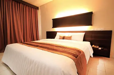 a bedroom with a large bed in a hotel room at Bakung Beach Resort in Kuta