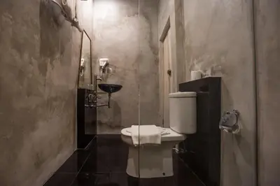 a bathroom with a toilet and a sink at Bali Breezz Hotel in Jimbaran