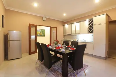 a kitchen and dining room with a table and chairs at Peninsula Beach Resort in Nusa Dua