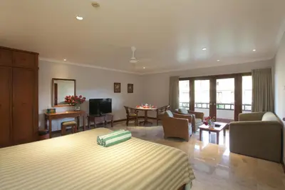 a hotel room with a bed and a living room at Peninsula Beach Resort in Nusa Dua