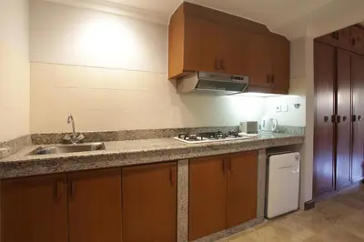 a kitchen with a sink and a counter top at Peninsula Beach Resort in Nusa Dua