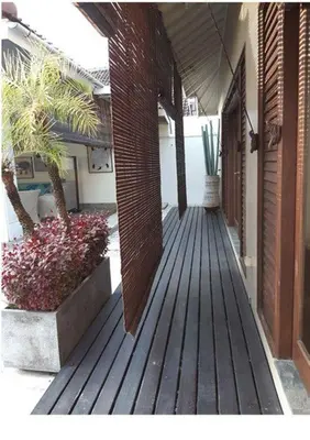a wooden porch with plants on a building at Villa Sukapadi in Seminyak