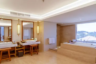 a bathroom with two sinks and a bath tub at Royal Suites at The Bandha in Legian