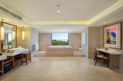 a large bathroom with a tub and a sink at Royal Suites at The Bandha in Legian