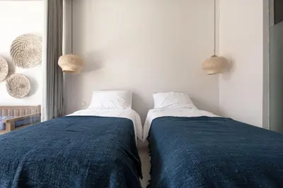 two beds sitting next to each other in a room at Pelangi 148 Beach Suites in Seminyak