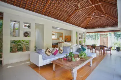 a living room with a couch and a table at Villa Bali Asri Batubelig in Seminyak