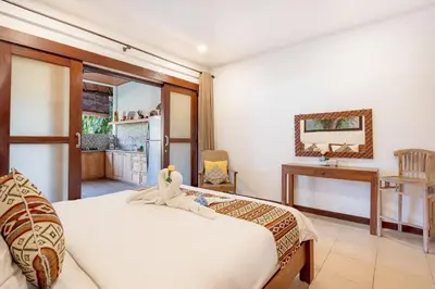 a bedroom with a bed and a desk and a mirror at Villa Star in Seminyak