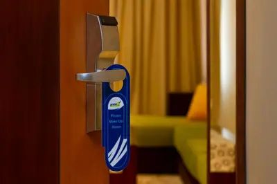 a close up of a door handle in a room at PrimeBiz Hotel Kuta in Kuta