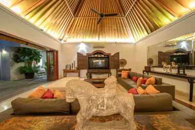 a living room with a couch and a tv at Villa Rubina - Luxury Pool Villa in Batu Belig Next to the Beach! in Seminyak