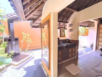 an outdoor bathroom with a sink and a shower at Villa Plawa Asri in Seminyak
