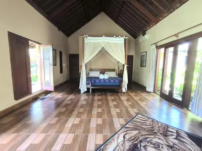 a bedroom with a bed with a canopy at Villa Plawa Asri in Seminyak