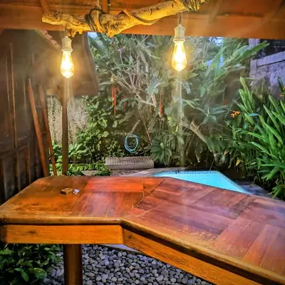 a wooden table sitting under a tent in a garden at Villa BAgus - near Seminyak beach & trendy shops, restaurants, cafes in Seminyak