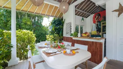 a dining room with a white table and chairs at Ocean Luxury Villas - Private Pool Seminayk in Seminyak