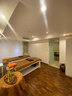 a living room with a table and a couch and a table sidx sidx at The Bene Hotel in Kuta