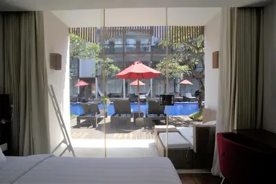 a hotel room with a view of a patio with a pool at The Bene Hotel in Kuta