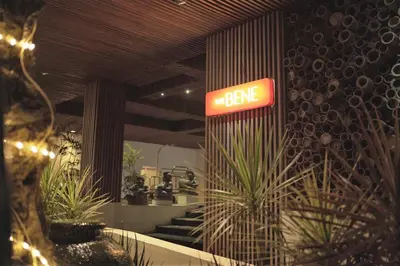 a sign that says the bake in a building with plants at The Bene Hotel in Kuta