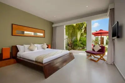 a bedroom with a bed and a tv and a window at Villa Miro - Luxury, 3 Bed, Central Seminyak in Seminyak