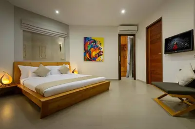 a bedroom with a large bed and a chair at Villa Miro - Luxury, 3 Bed, Central Seminyak in Seminyak
