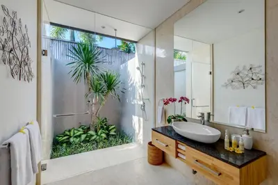 a bathroom with a sink and a large mirror at Aramanis in Seminyak