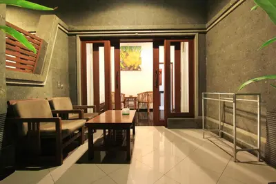 a living room with a table and chairs at Letos Kubu Homestay in Kuta