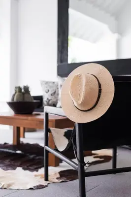a hat sitting on a chair in a living room at Villa Salsa in Seminyak