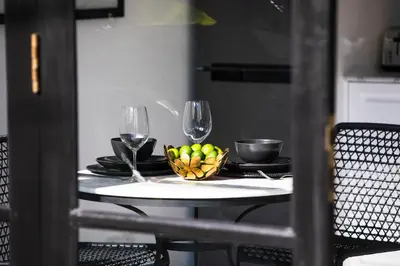 a table with two wine glasses and a bowl of fruit at Villa Chino in Seminyak