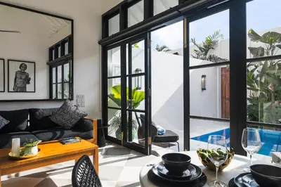 a living room with a couch and a table at Villa Chino in Seminyak