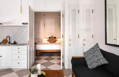 a living room with a couch and a bedroom at Villa Chino in Seminyak