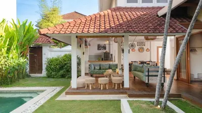 a gazebo in the backyard of a house at Villa Umara by Villa Finder in Seminyak