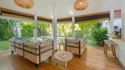 a bathroom with two wooden beds in a room at Villa Umara by Villa Finder in Seminyak