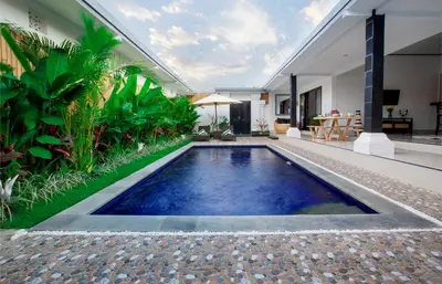 a swimming pool in the middle of a house at Aurora Villa, Seminyak in Seminyak