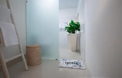 a welcome mat on the floor in a room with a plant at Aurora Villa, Seminyak in Seminyak