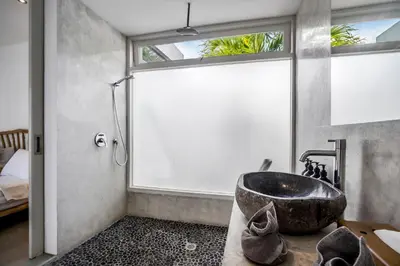 a bathroom with a large sink and a window at Villa Nakal by Alfred in Bali in Seminyak