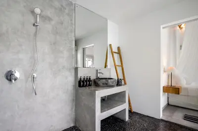 a bathroom with a shower and a table with a sink at Villa Nakal by Alfred in Bali in Seminyak