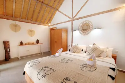 a bedroom with a large bed in a room at Villa Balimasan 10 mins to Canggu in Seminyak