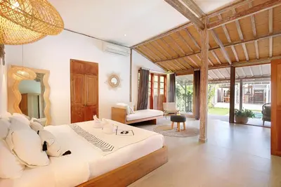 a bedroom with a large bed and a living room at Villa Balimasan 10 mins to Canggu in Seminyak