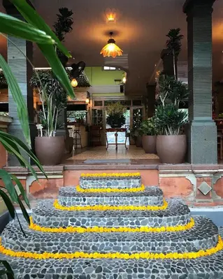 a group of yellow and black steps in a lobby at Three Brothers Bali Legian Bungalows & Villas in Legian