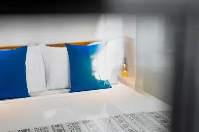a bed with blue and white pillows on top of it at Villa Opihr in Seminyak