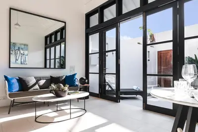 a living room with a couch and a table at Villa Opihr in Seminyak