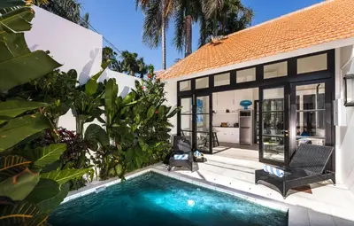 a house with a swimming pool in front of a house at Villa Opihr in Seminyak