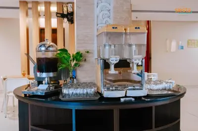 a counter with a coffee maker and glasses on it at Siesta Legian in Legian