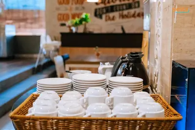 a basket of cups and plates on a table at Siesta Legian in Legian