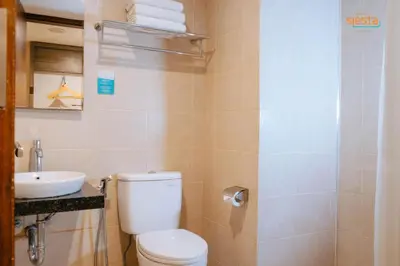 a bathroom with a toilet and a sink at Siesta Legian in Legian