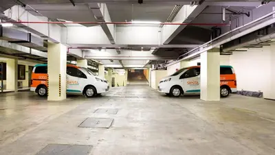 three parked cars parked in a parking garage at Siesta Legian in Legian