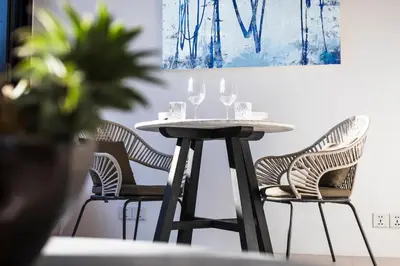 a table and chairs with wine glasses on it at Villa Saffron in Seminyak
