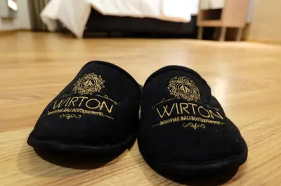 two black slippers sitting on a wooden floor at Wirton Seminyak in Denpasar