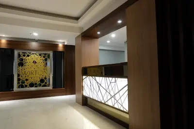 a hallway of a building with a view of a window at Wirton Seminyak in Denpasar
