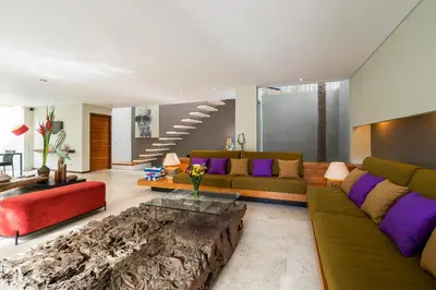 a living room with a couch and a table at Villa Athena in Seminyak
