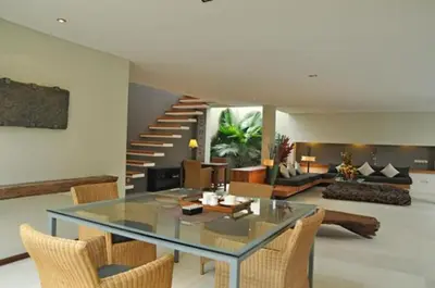 a living room with a glass table and chairs at Villa Athena in Seminyak
